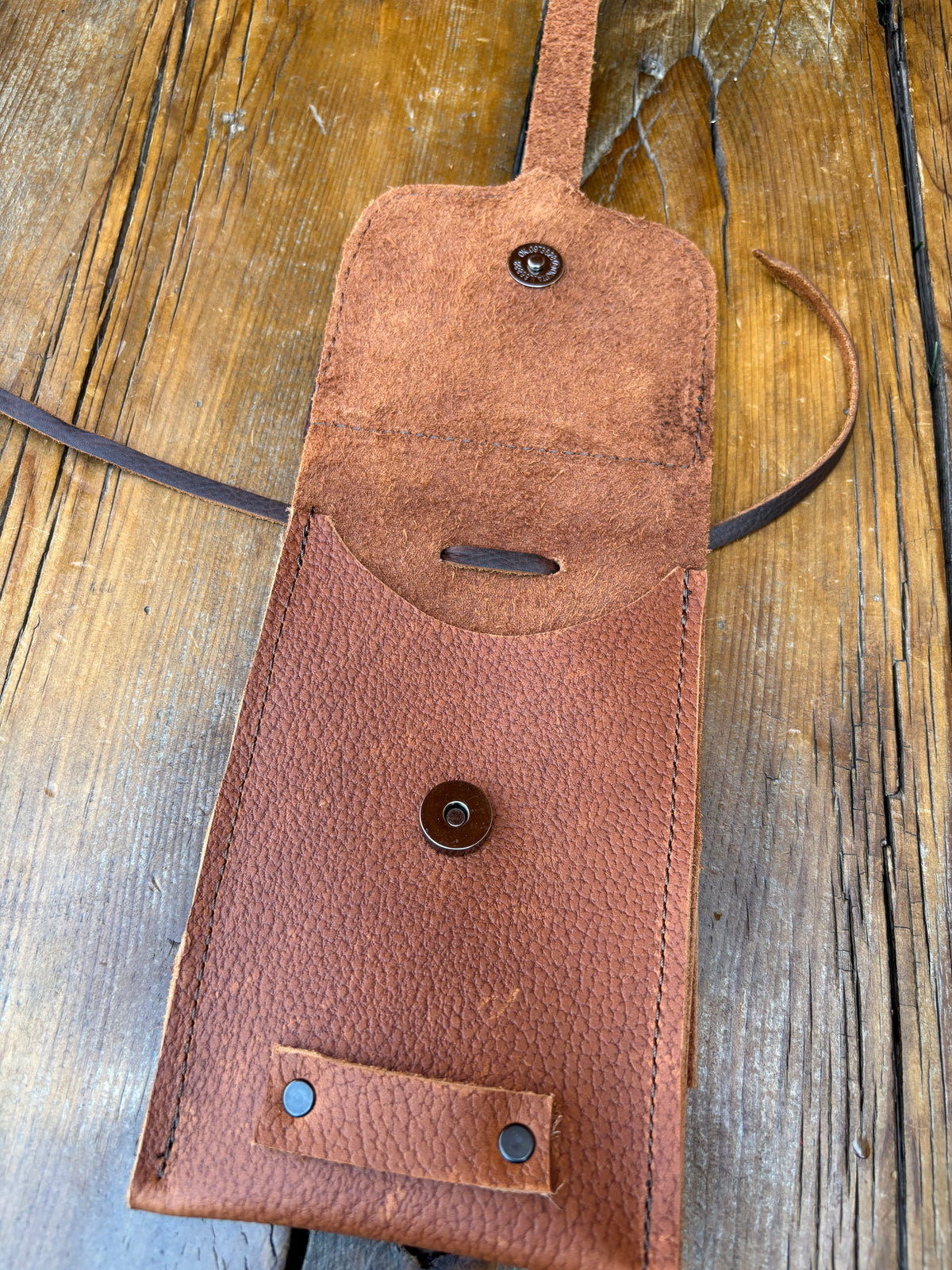 Saddle pouch cell phone holder