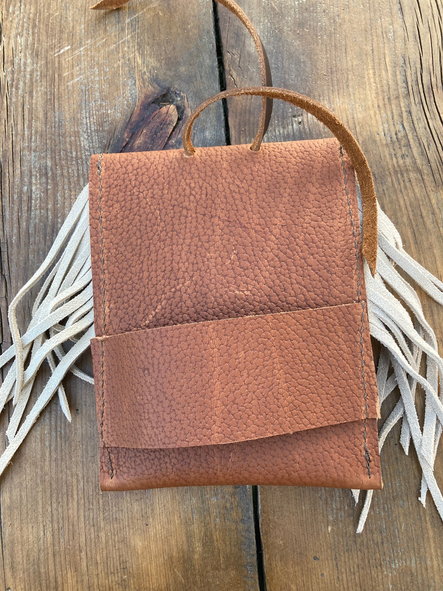 Saddle pouch cell phone holder