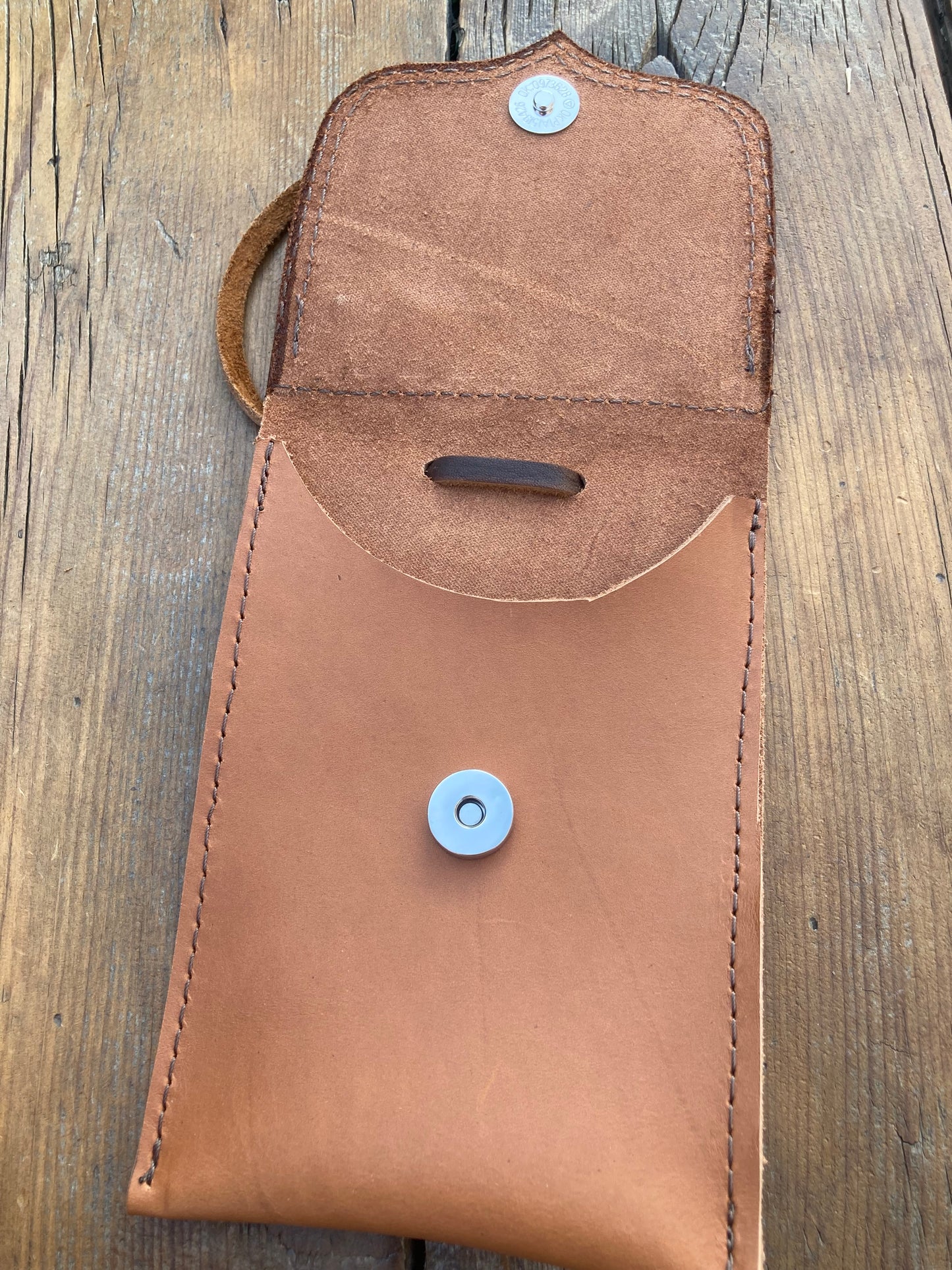 Saddle pouch cell phone holder