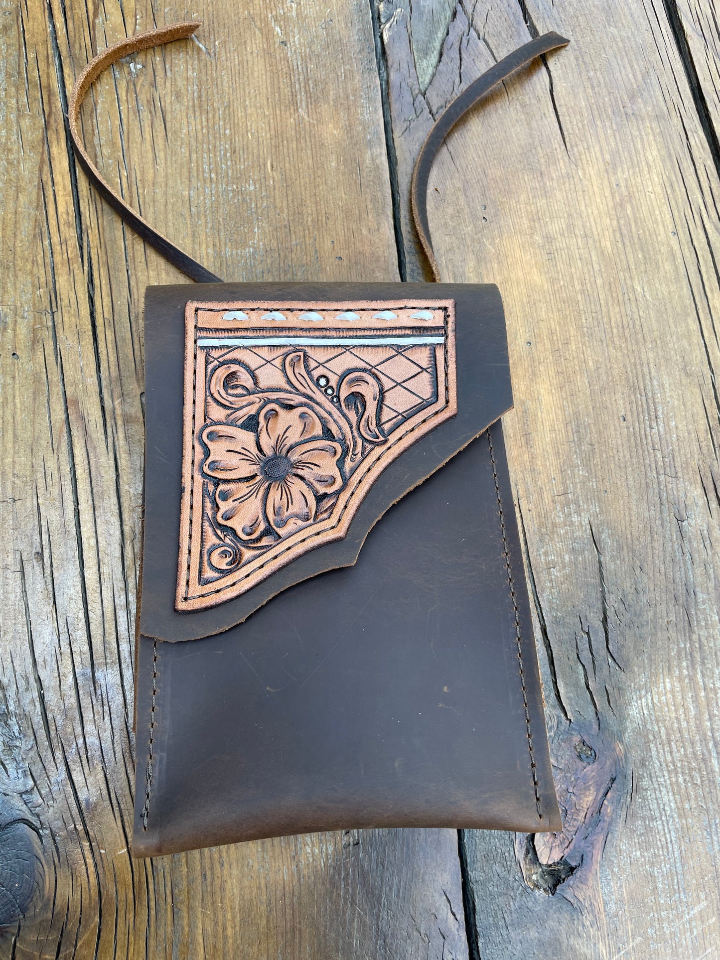 Saddle pouch cell phone holder