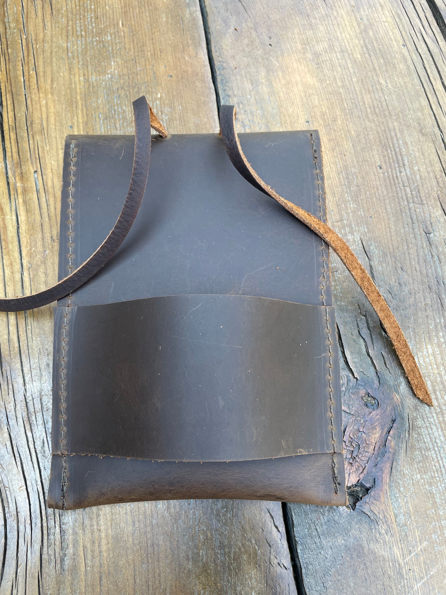 Saddle pouch cell phone holder