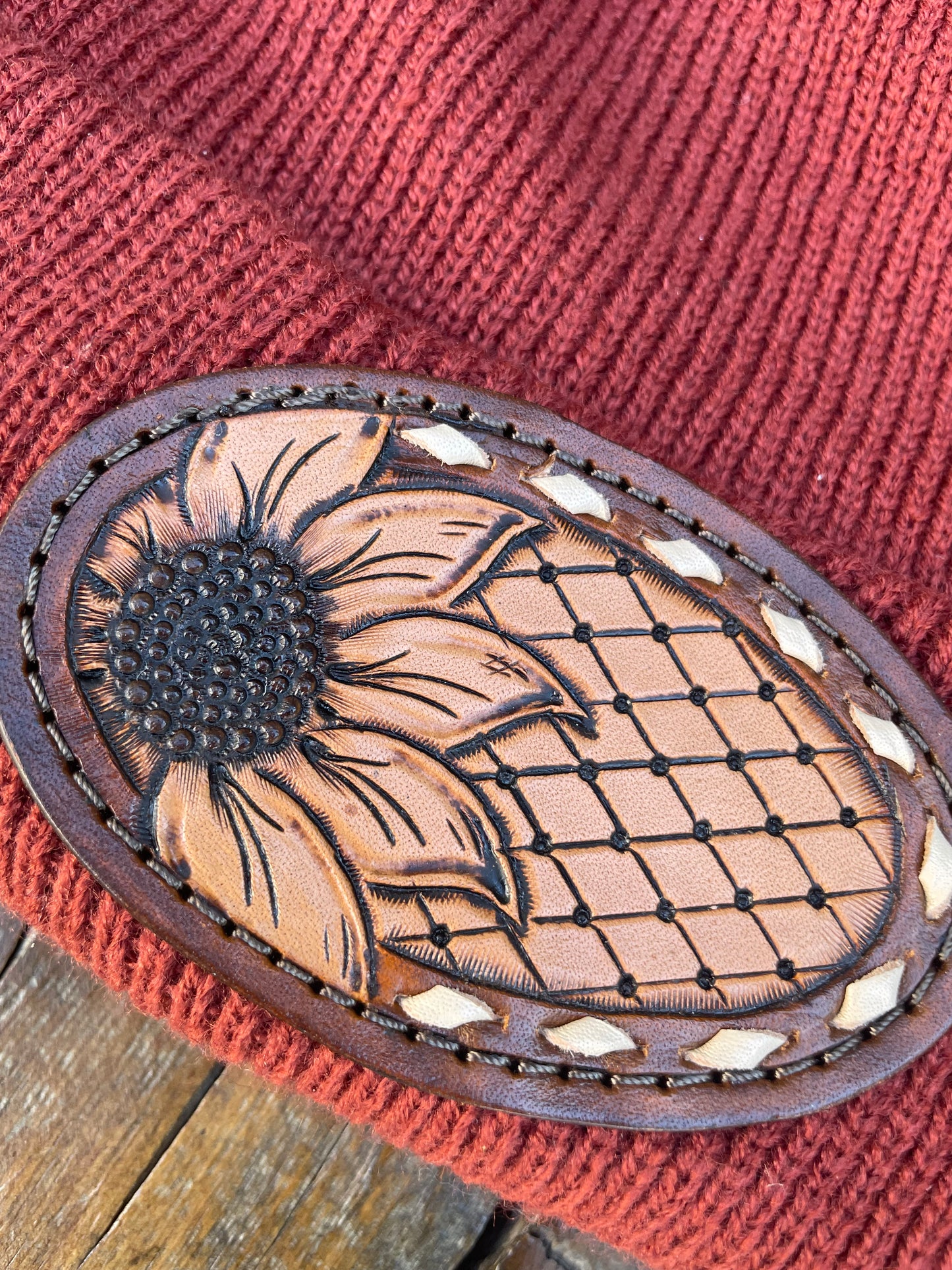 Rust color beanie with sunflower and buck stitch