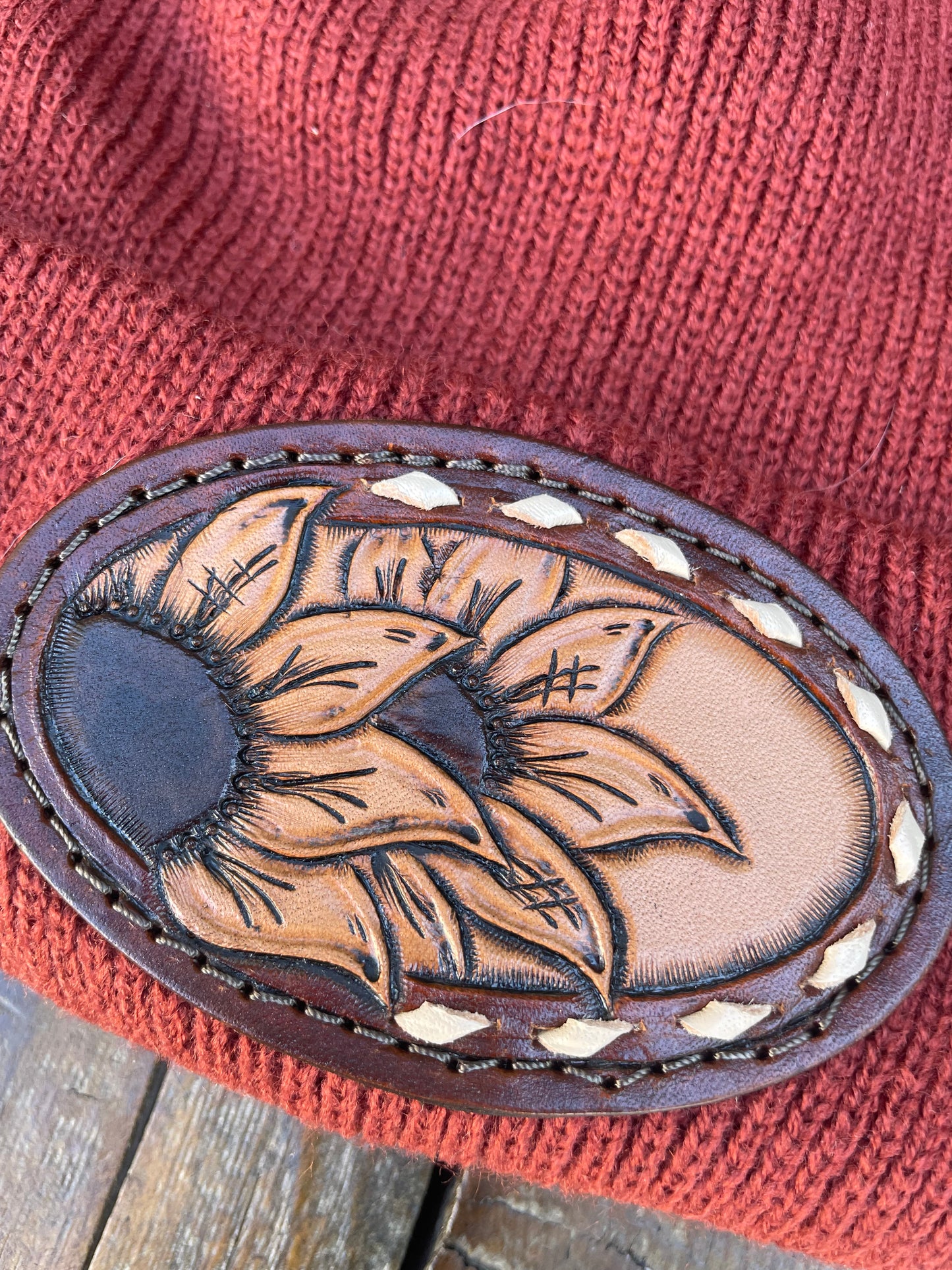 Rust color beanie with sunflower and buck stitch