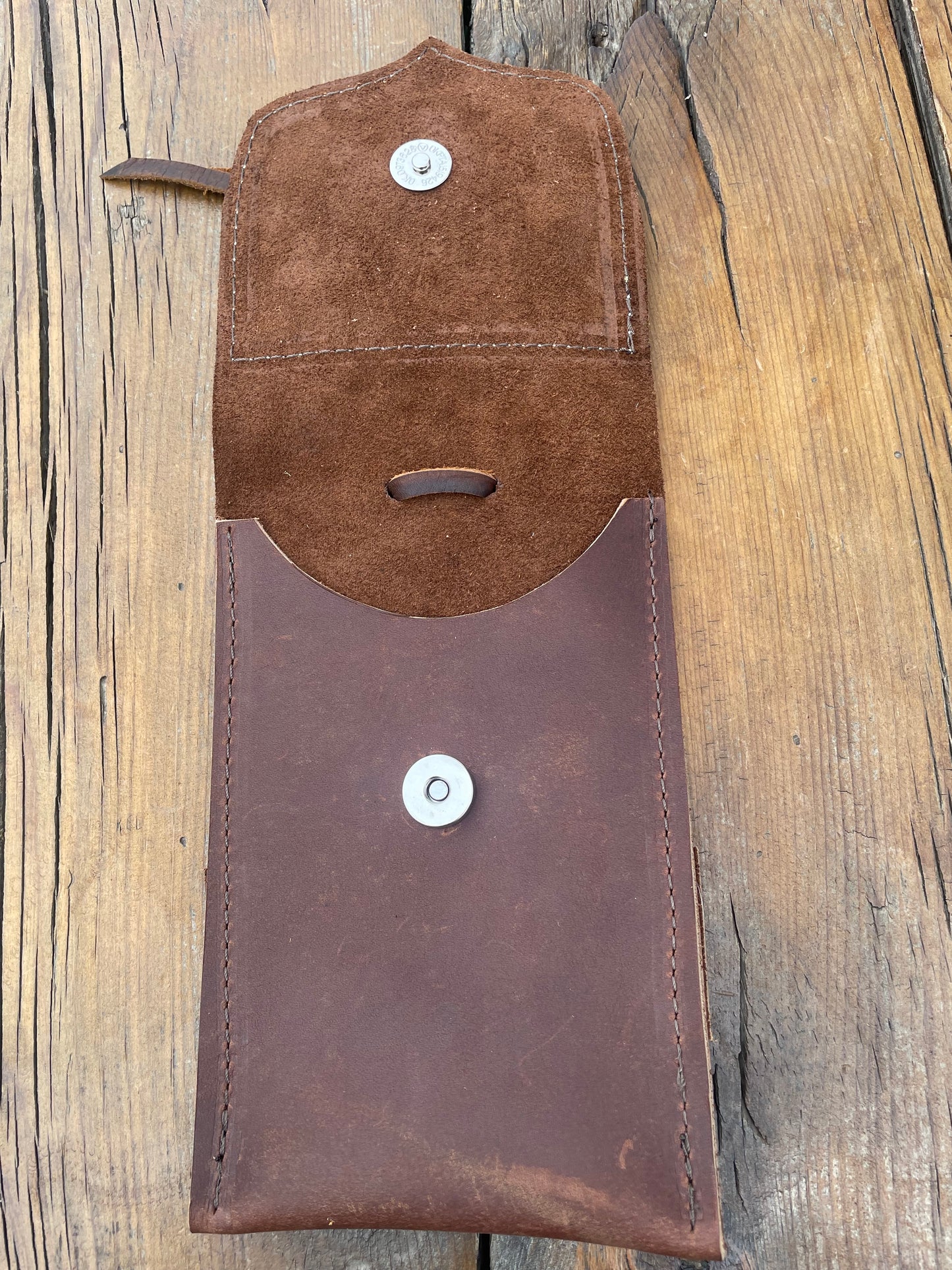 Saddle pouch cell phone holder