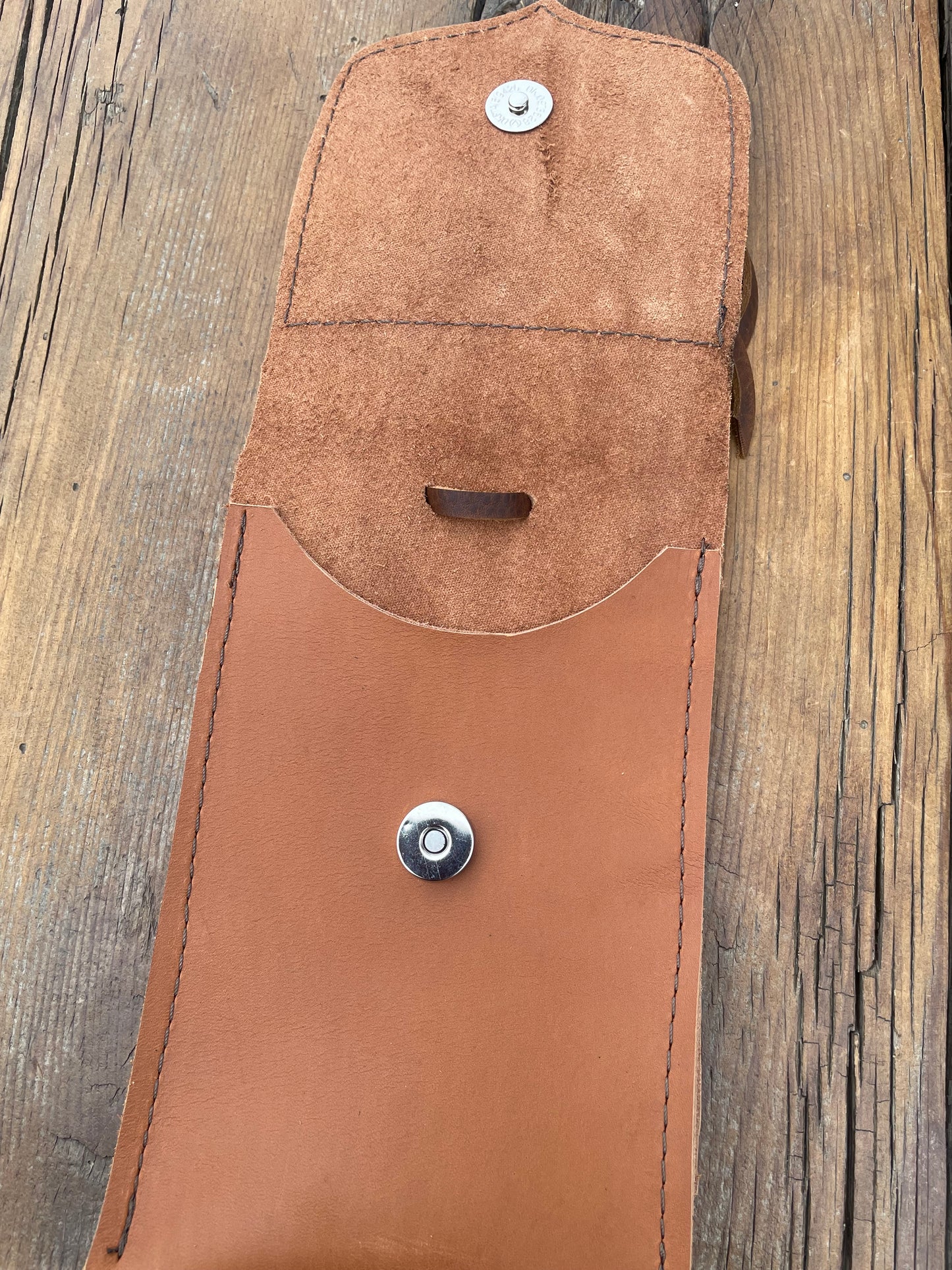 Saddle pouch cell phone holder