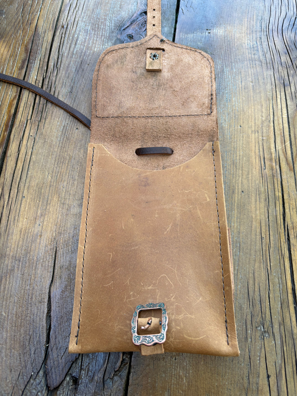 Saddle pouch cell phone holder