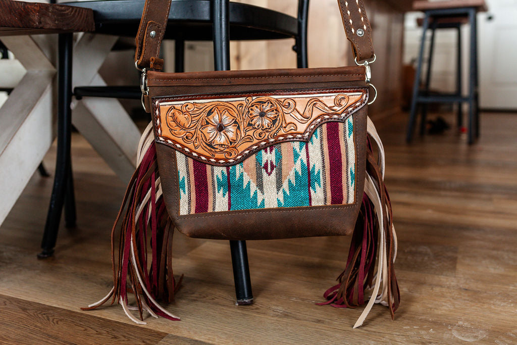 Purse with turquoise/maroon inlay, multicolored fringe & floral leather patch