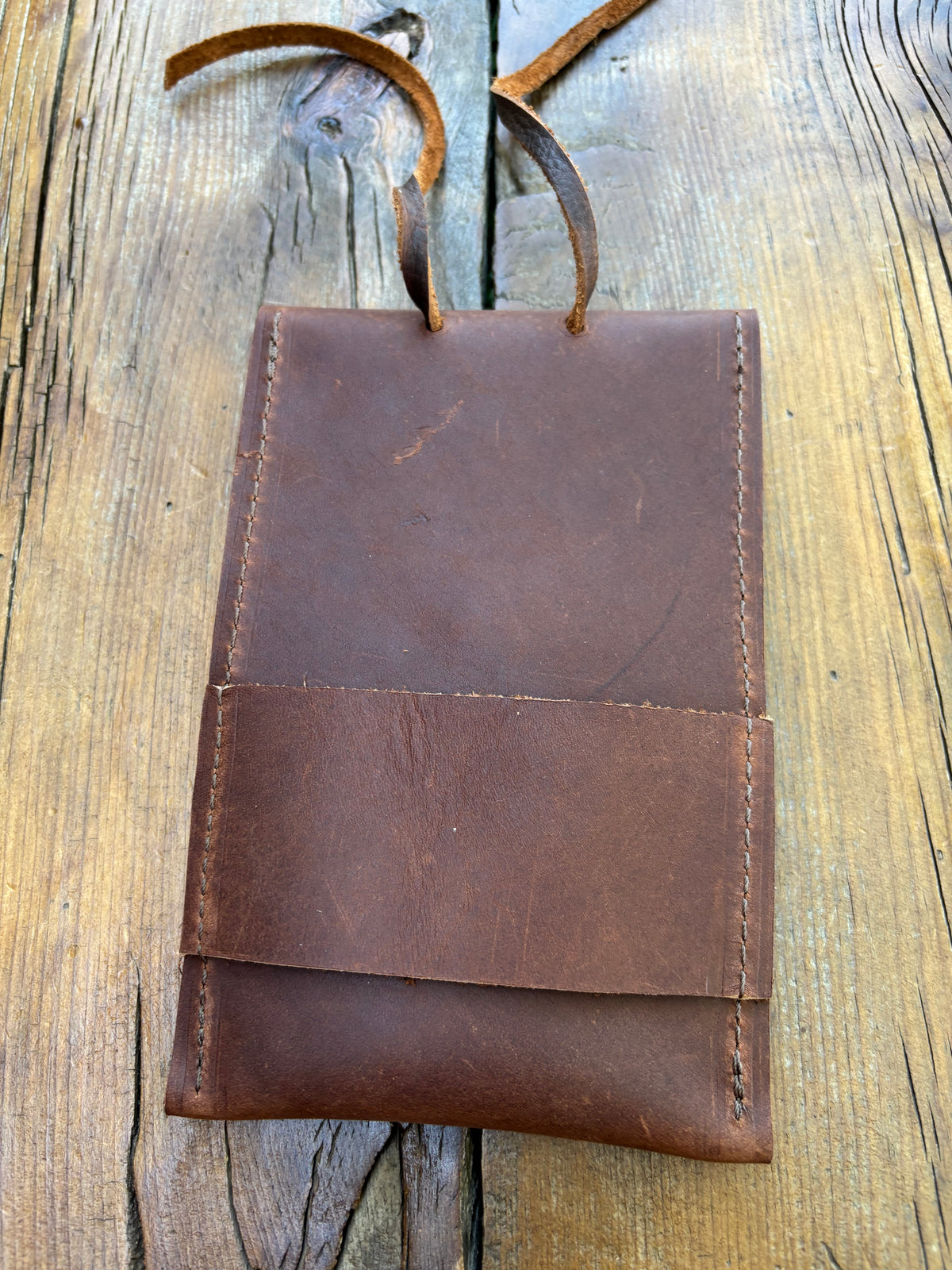 Saddle pouch cell phone holder