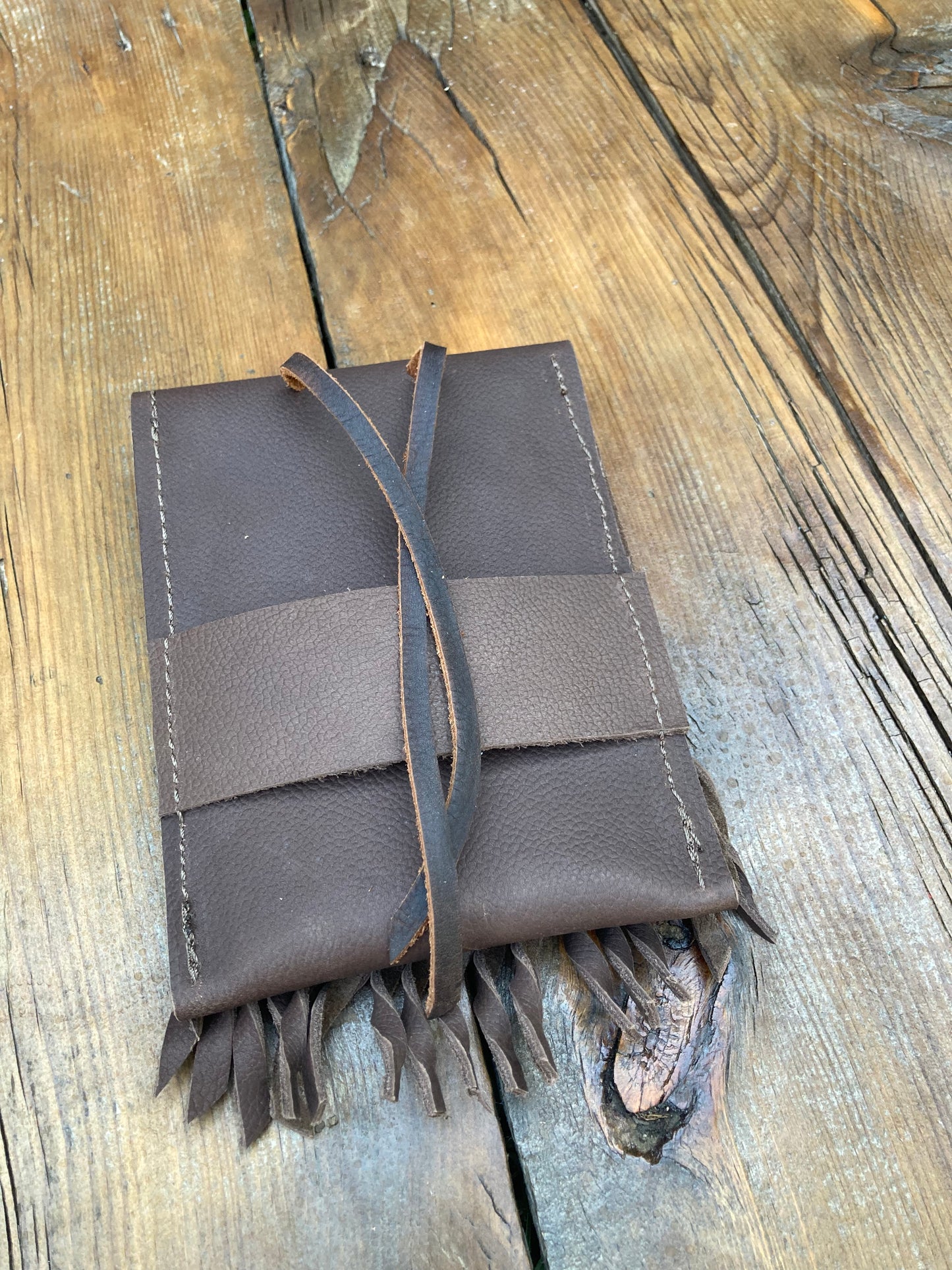 Saddle pouch cell phone holder