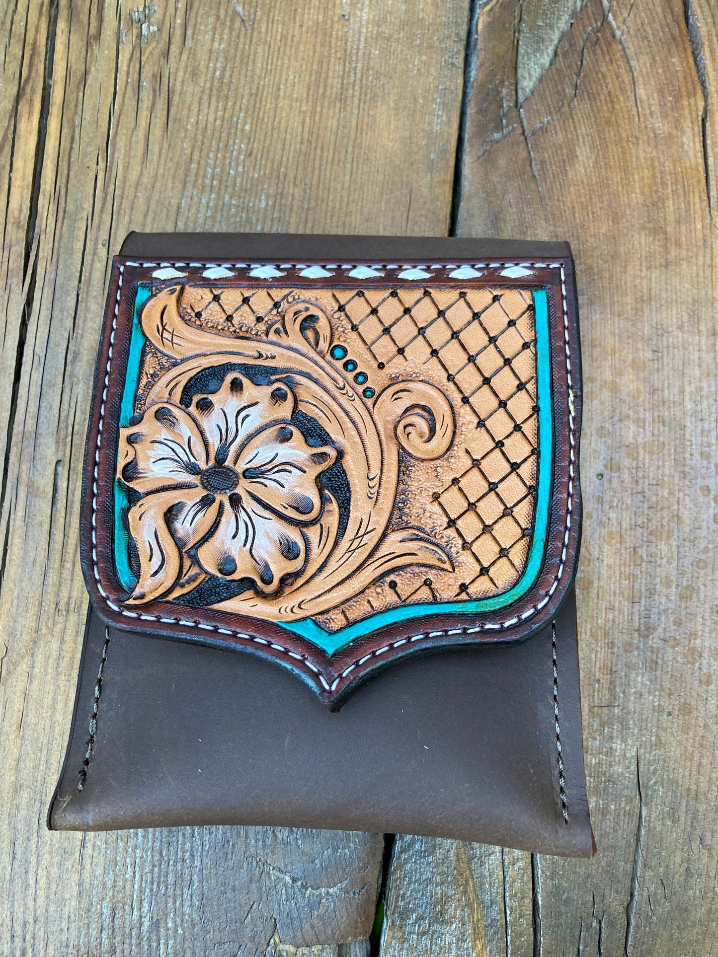 Saddle pouch cell phone holder