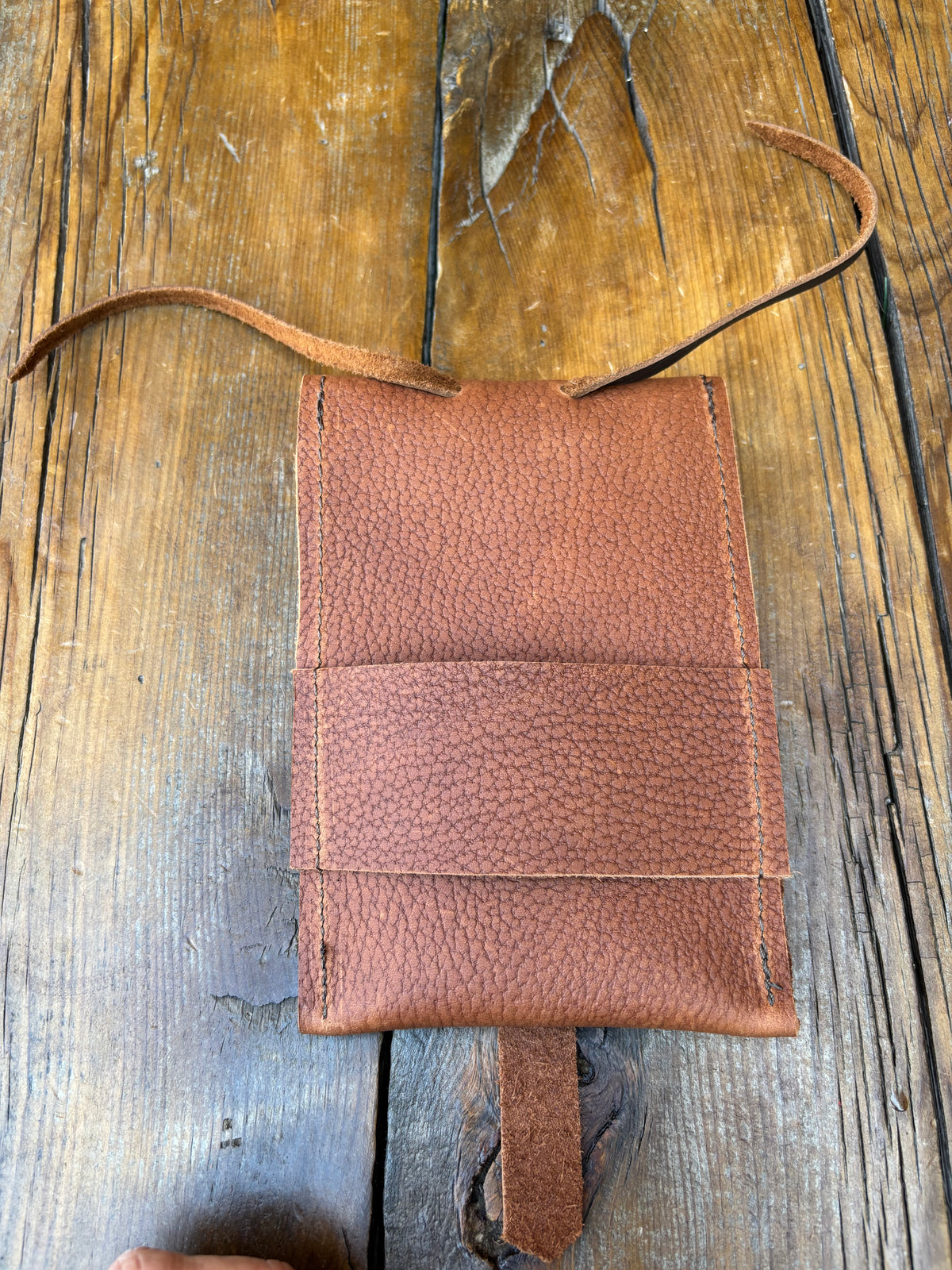 Saddle pouch cell phone holder