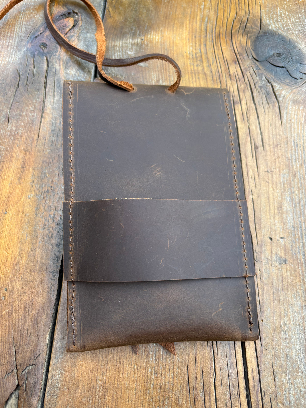 Saddle pouch cell phone holder