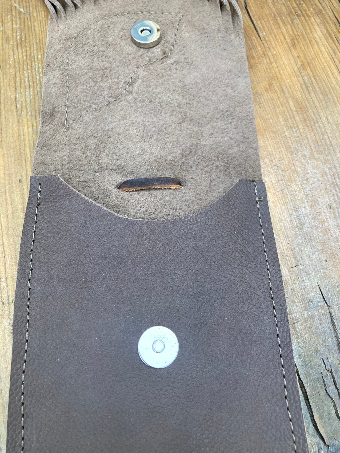 Saddle pouch cell phone holder