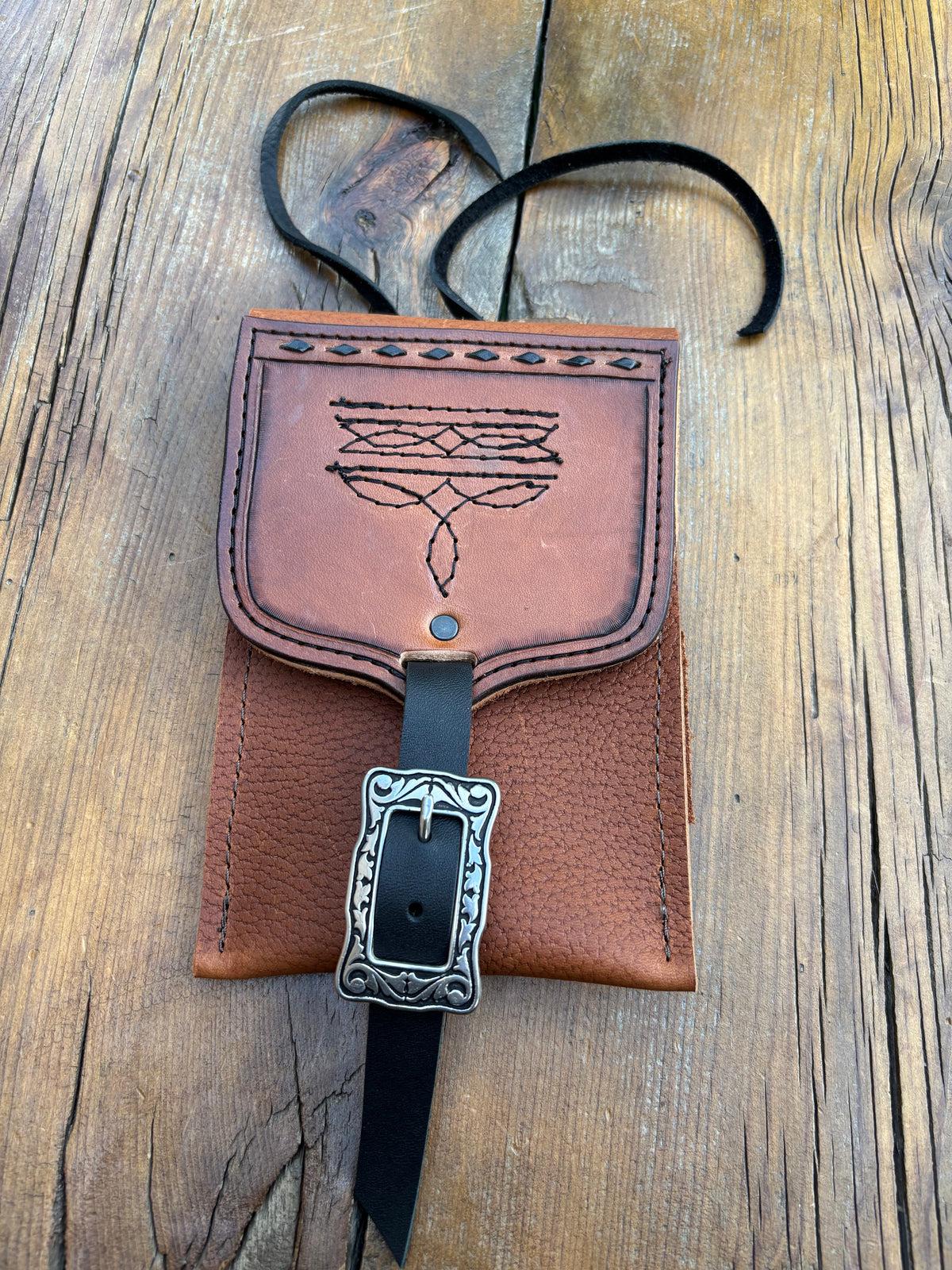 Saddle pouch cell phone holder