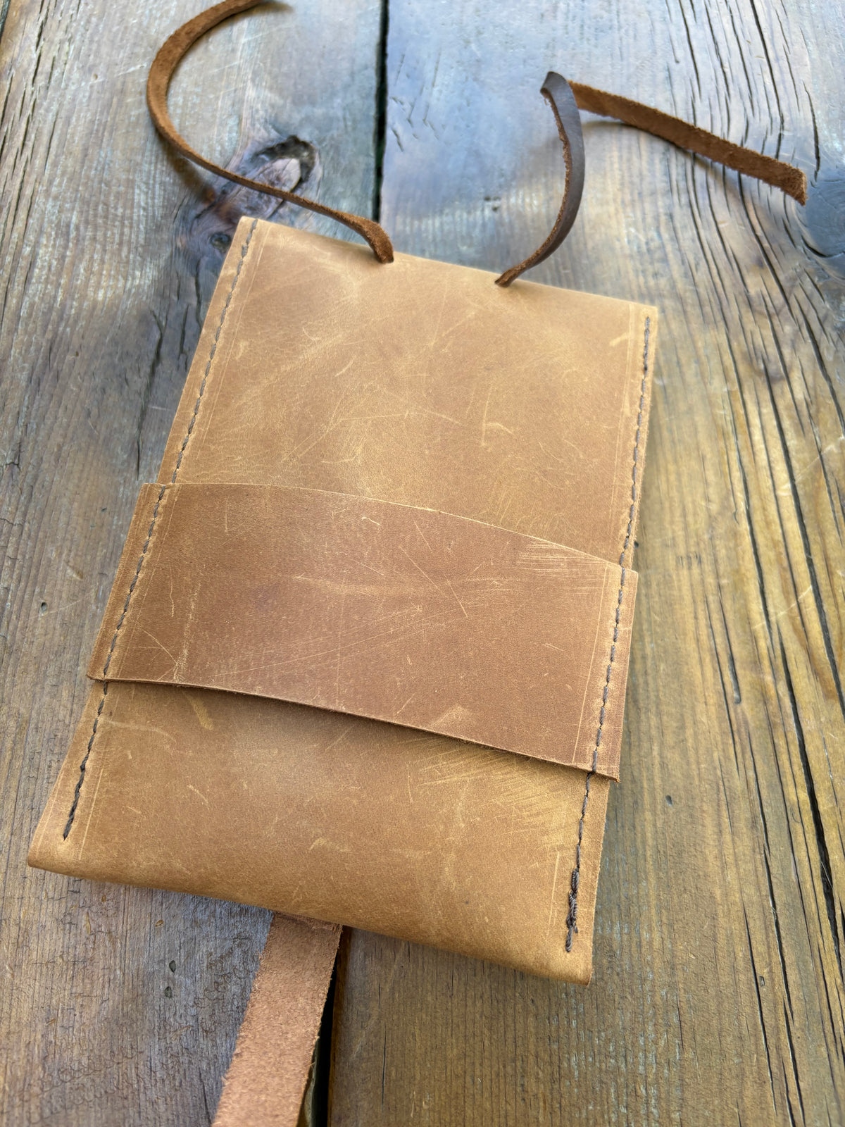 Saddle pouch cell phone holder