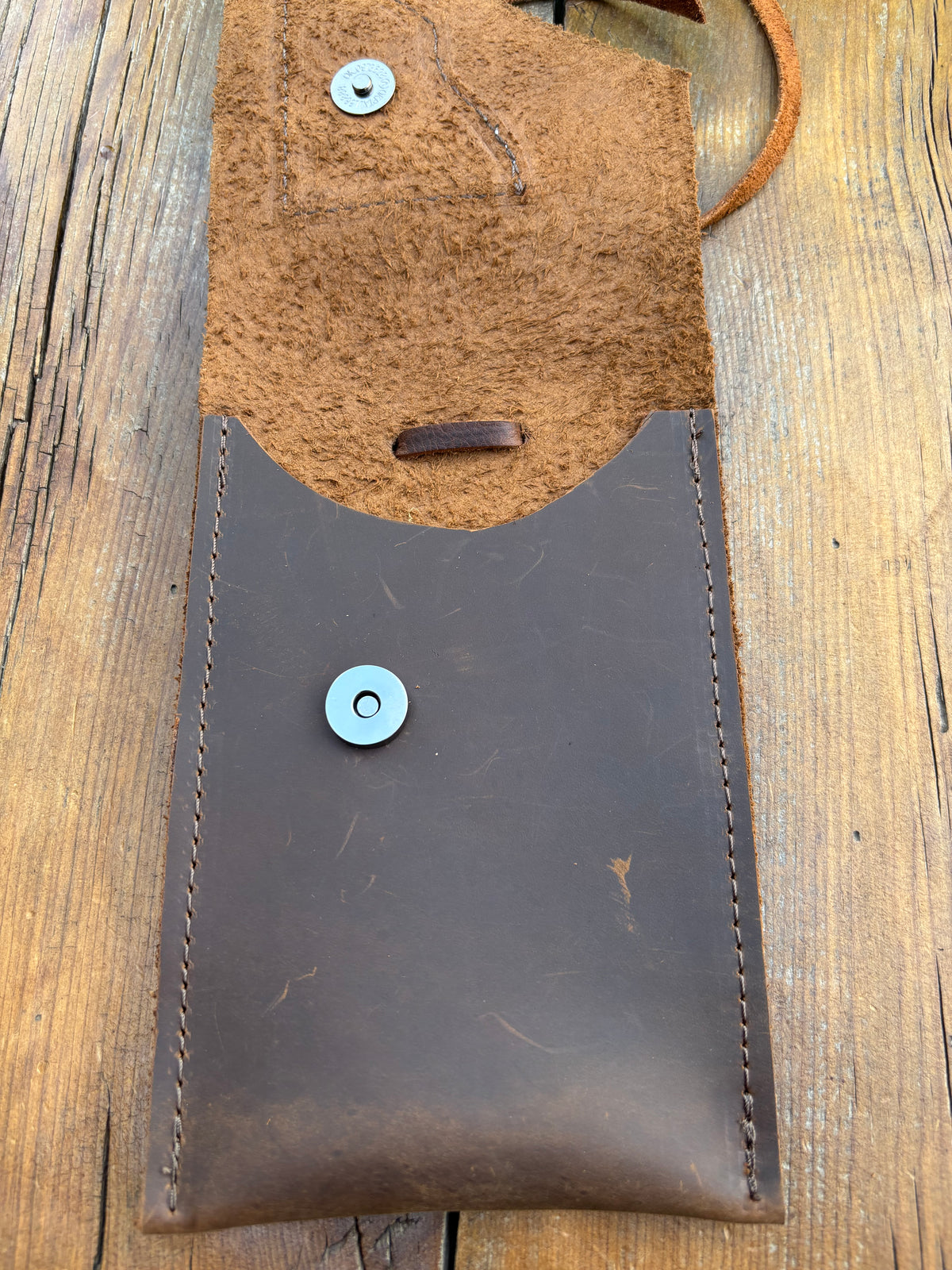 Saddle pouch cell phone holder