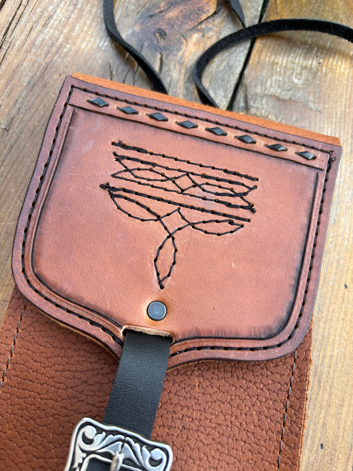 Saddle pouch cell phone holder