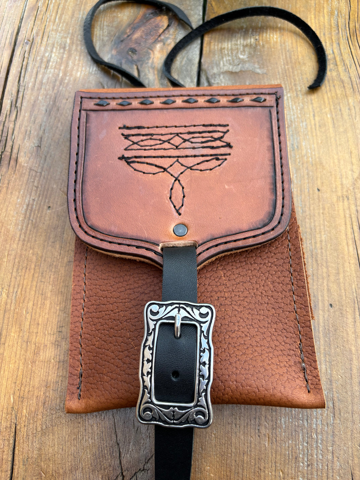 Saddle pouch cell phone holder