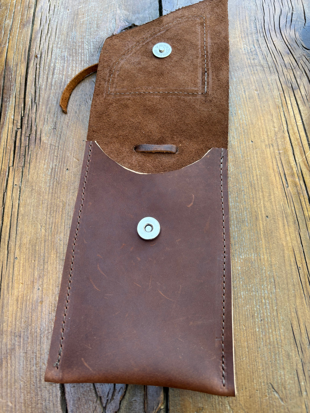 Saddle pouch cell phone holder