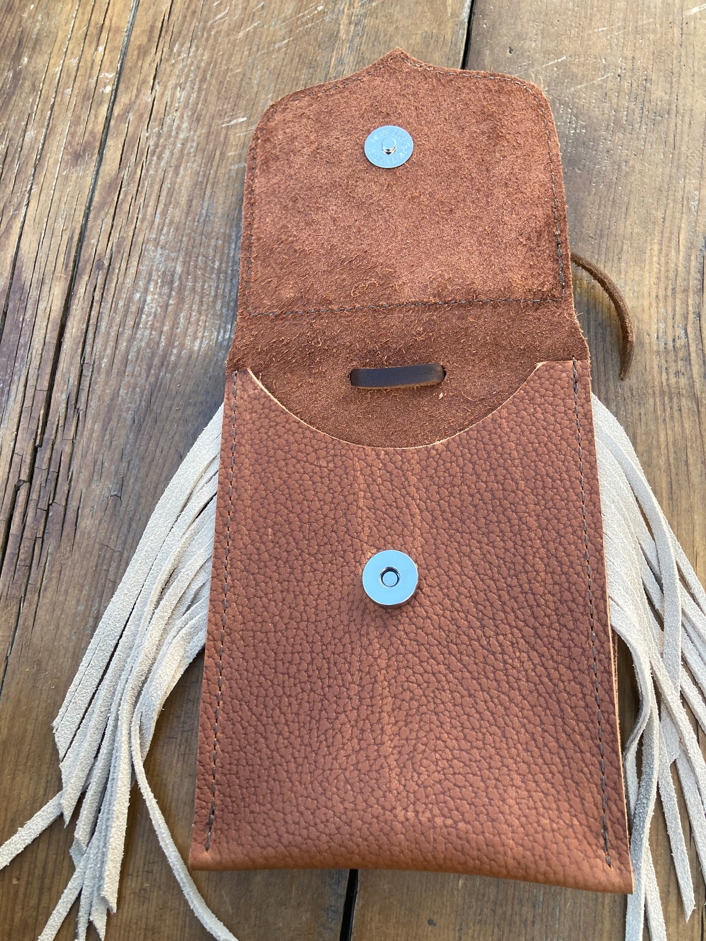 Saddle pouch cell phone holder