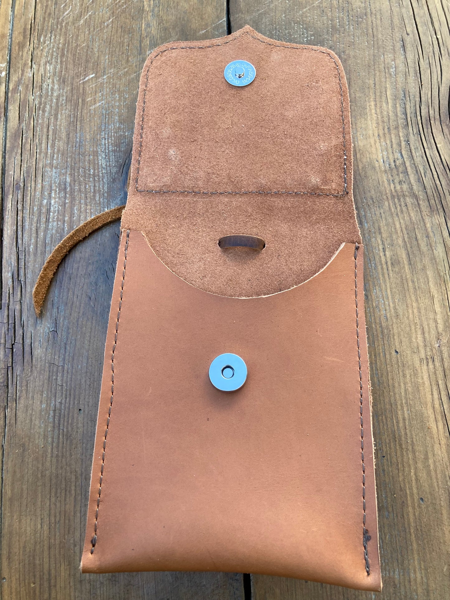 Saddle pouch cell phone holder