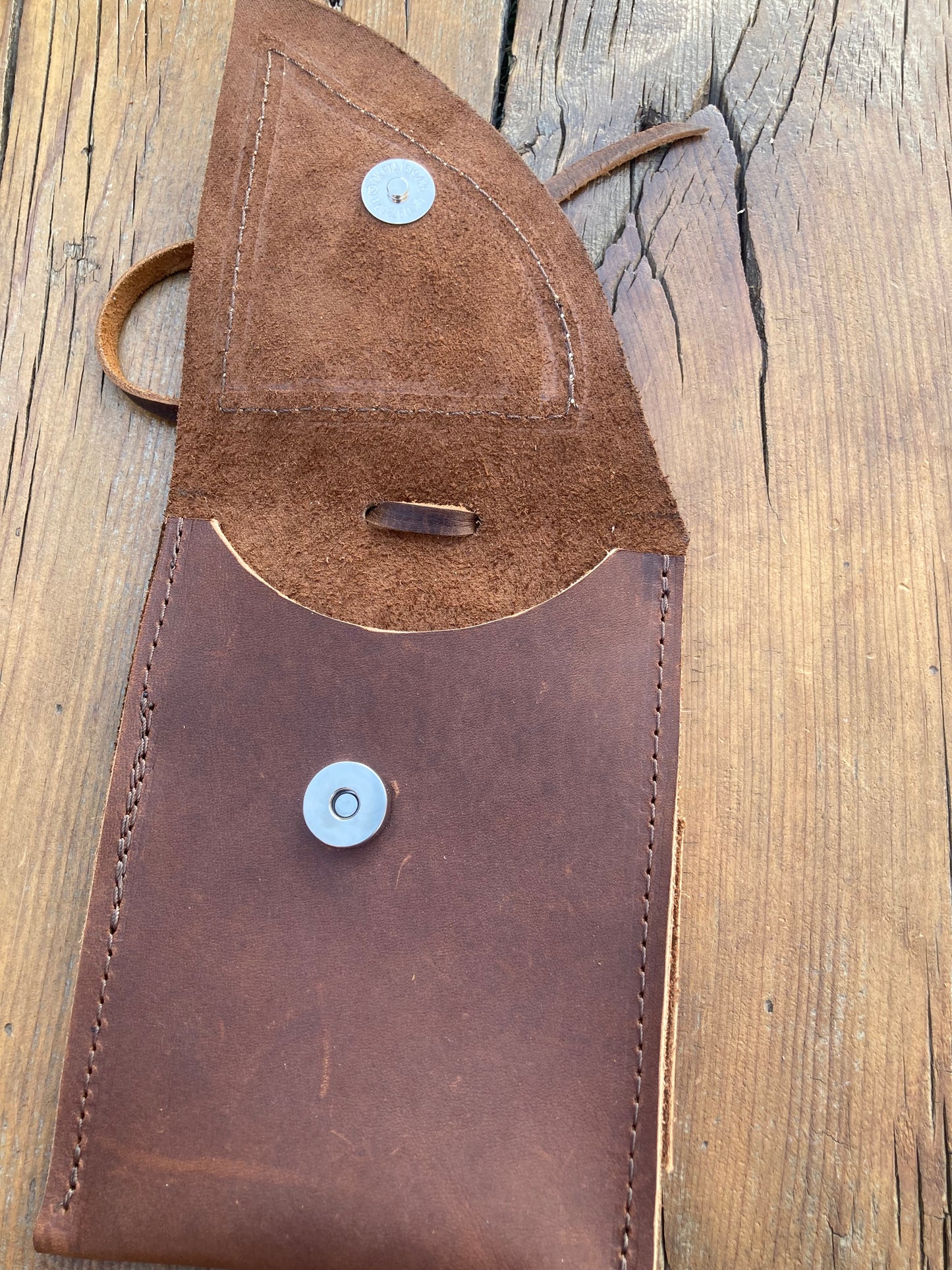 Saddle pouch cell phone holder