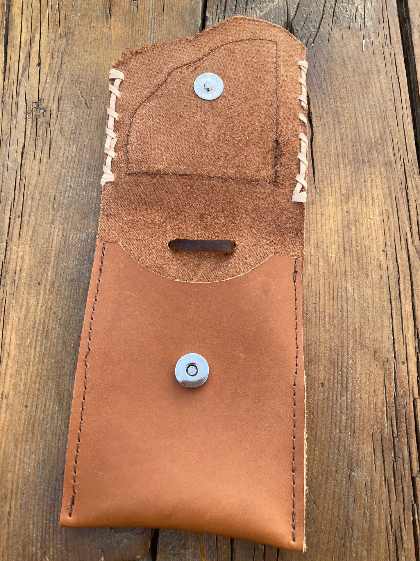 Saddle pouch cell phone holder