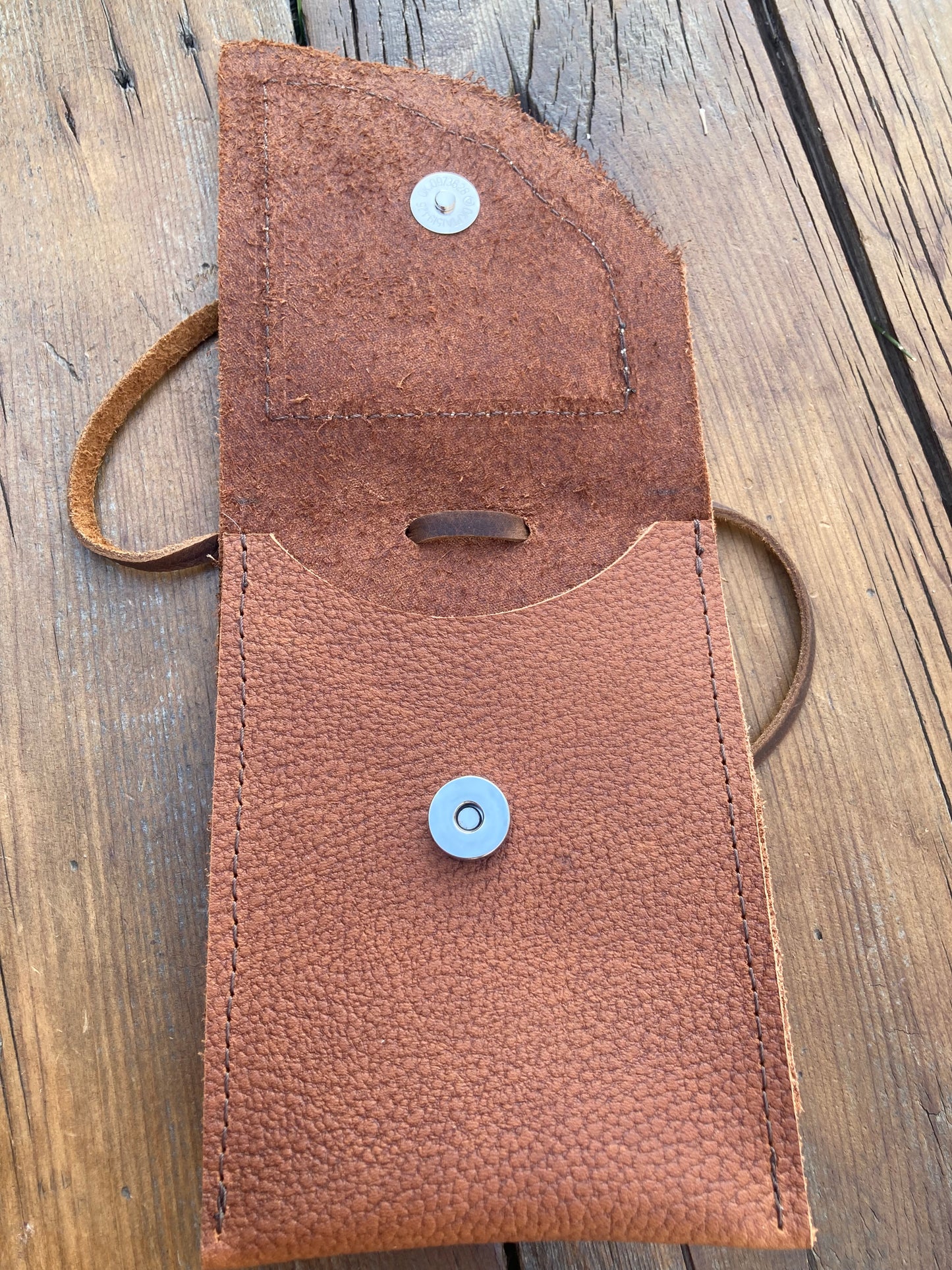 Saddle pouch cell phone holder