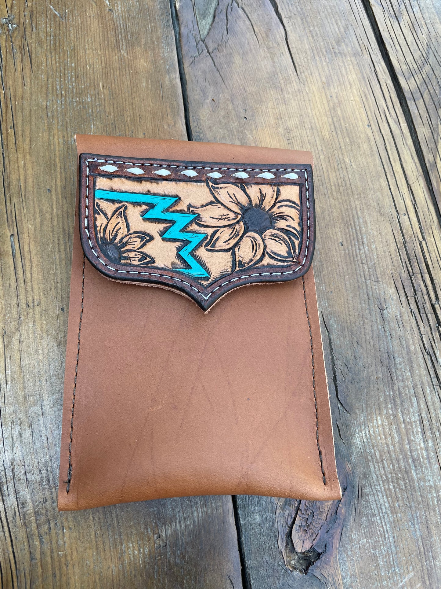 Saddle pouch cell phone holder