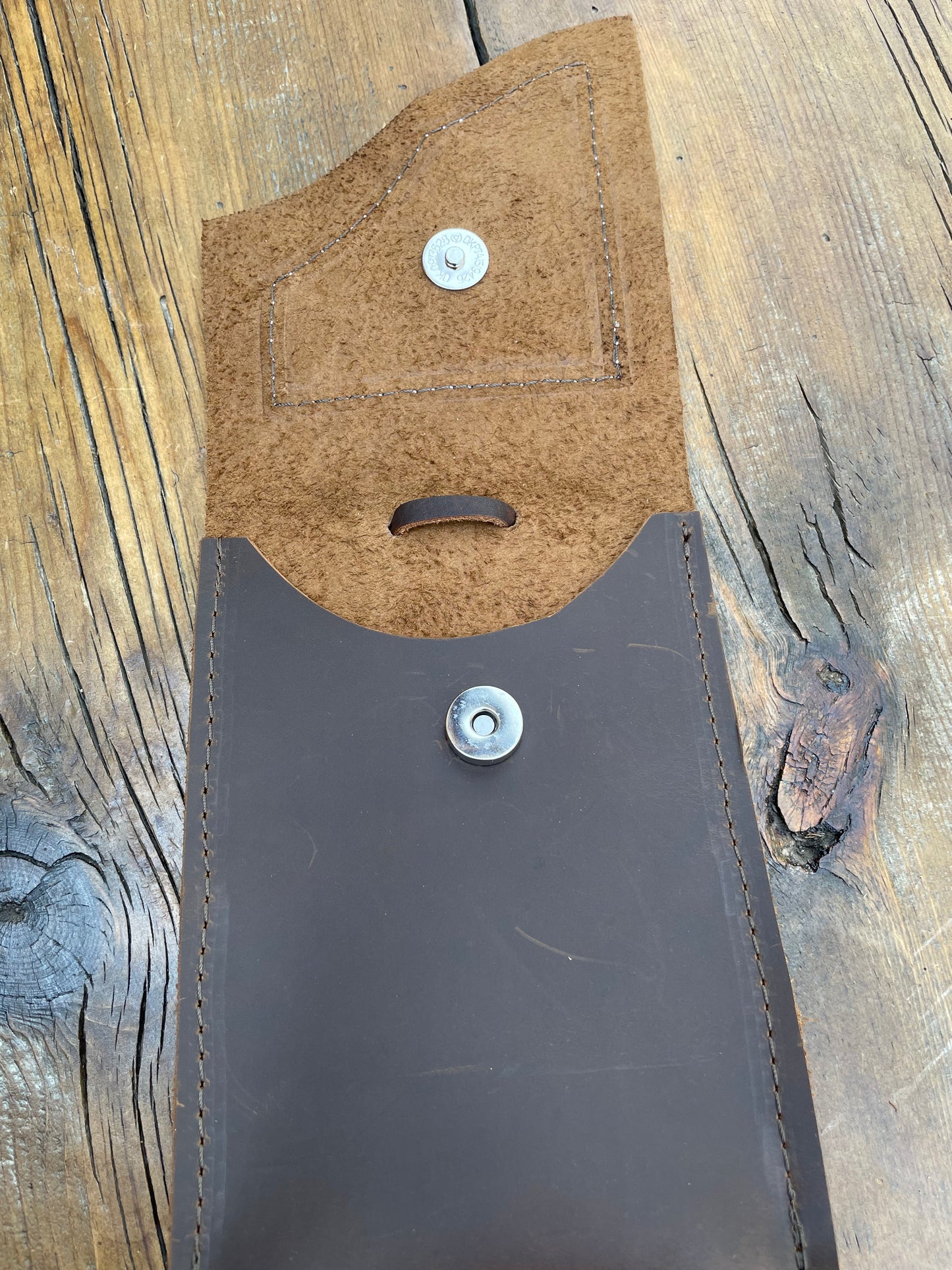 Saddle pouch cell phone holder