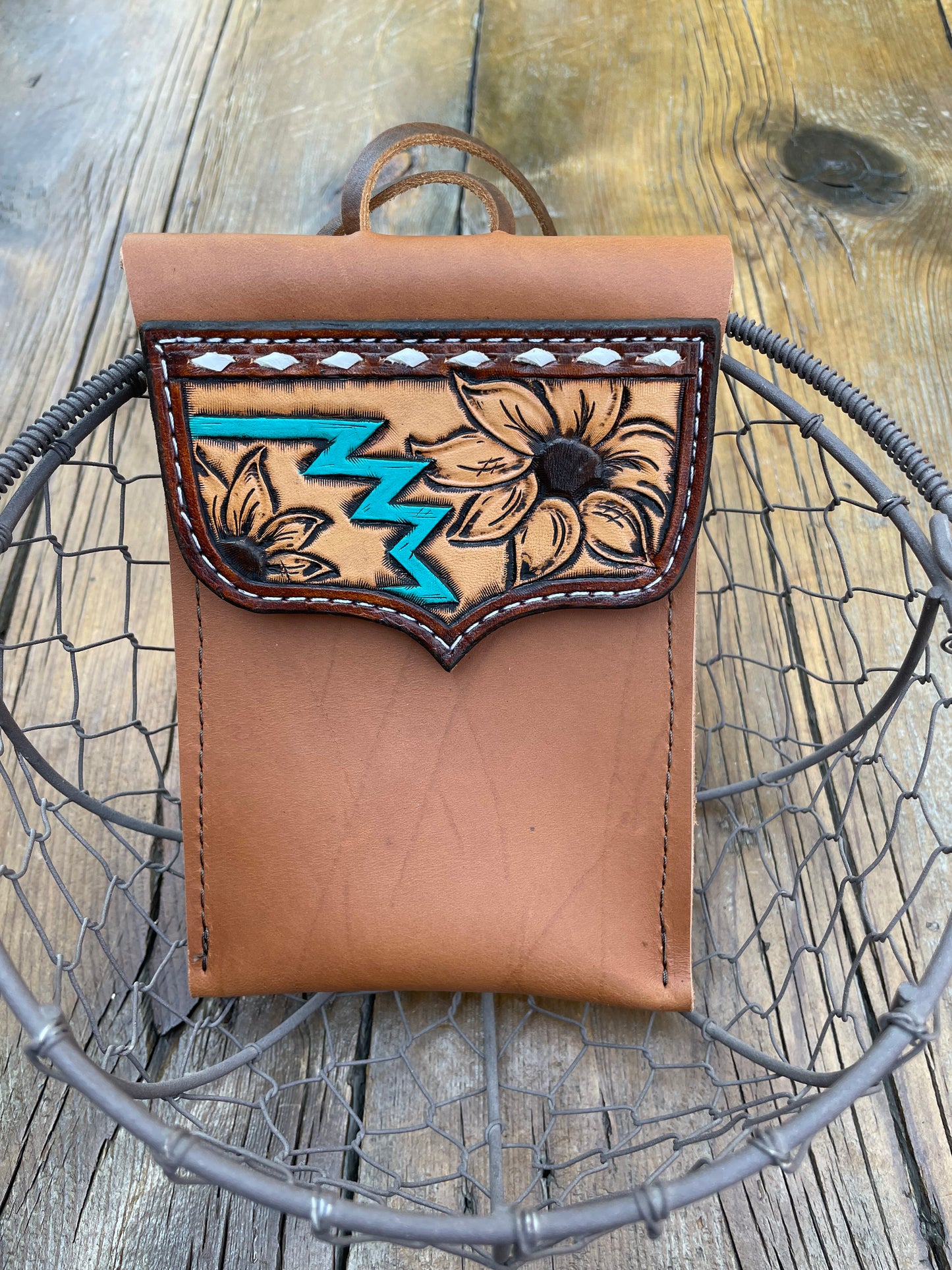 Saddle pouch cell phone holder