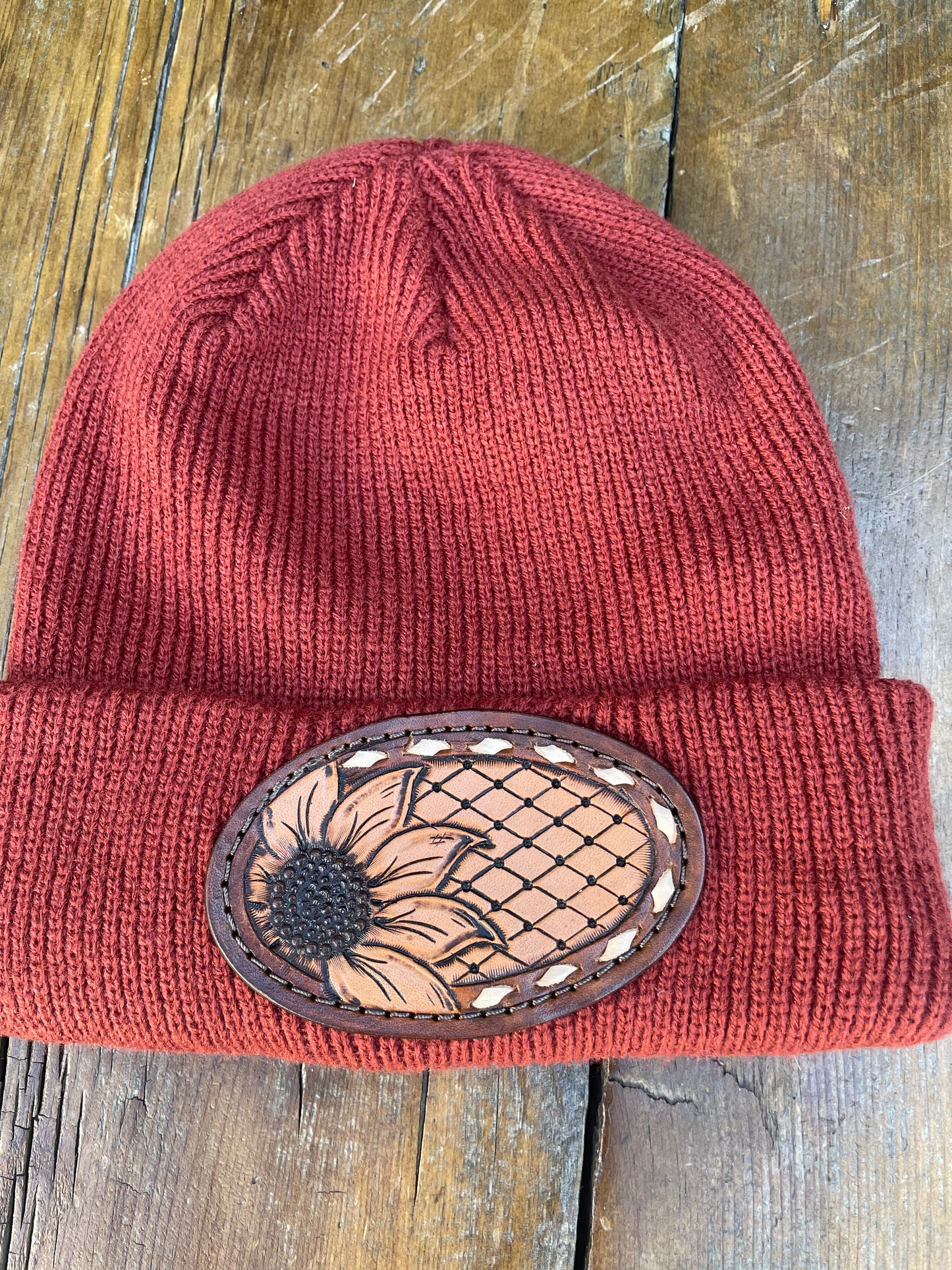 Rust color beanie with sunflower and buck stitch