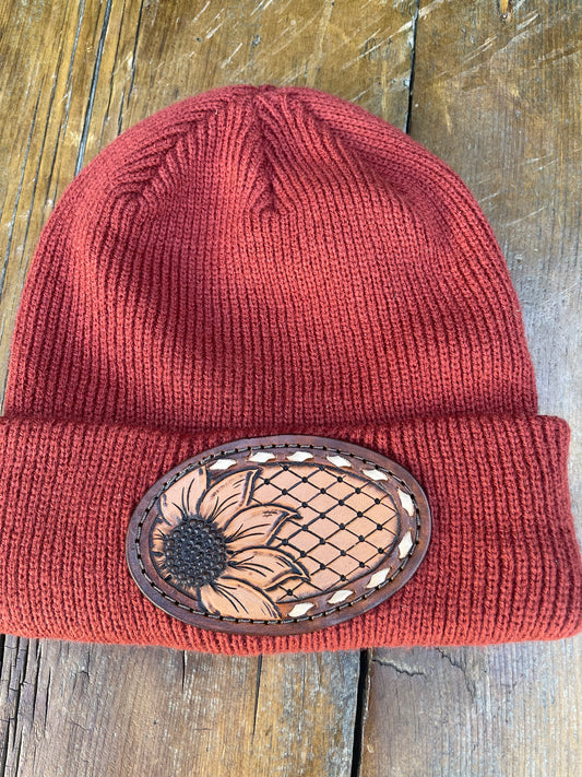 Rust color beanie with sunflower and buck stitch