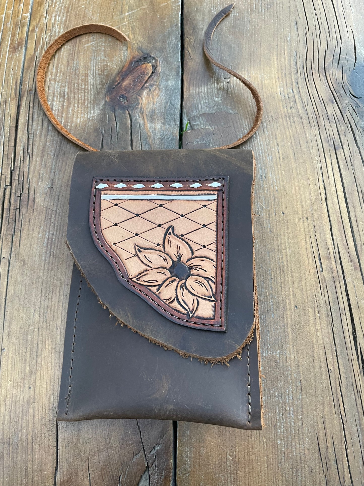 Saddle pouch cell phone holder
