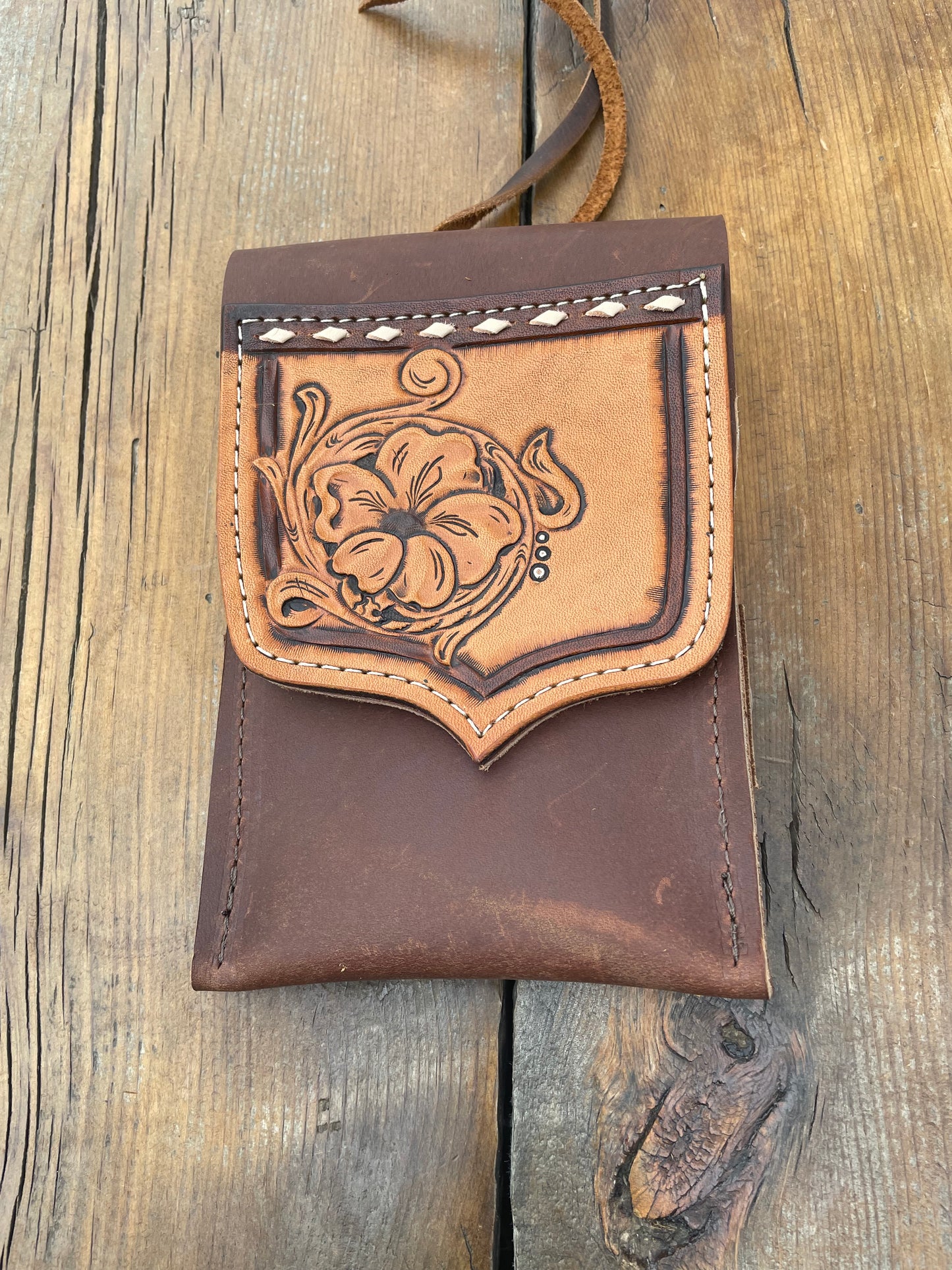 Saddle pouch cell phone holder