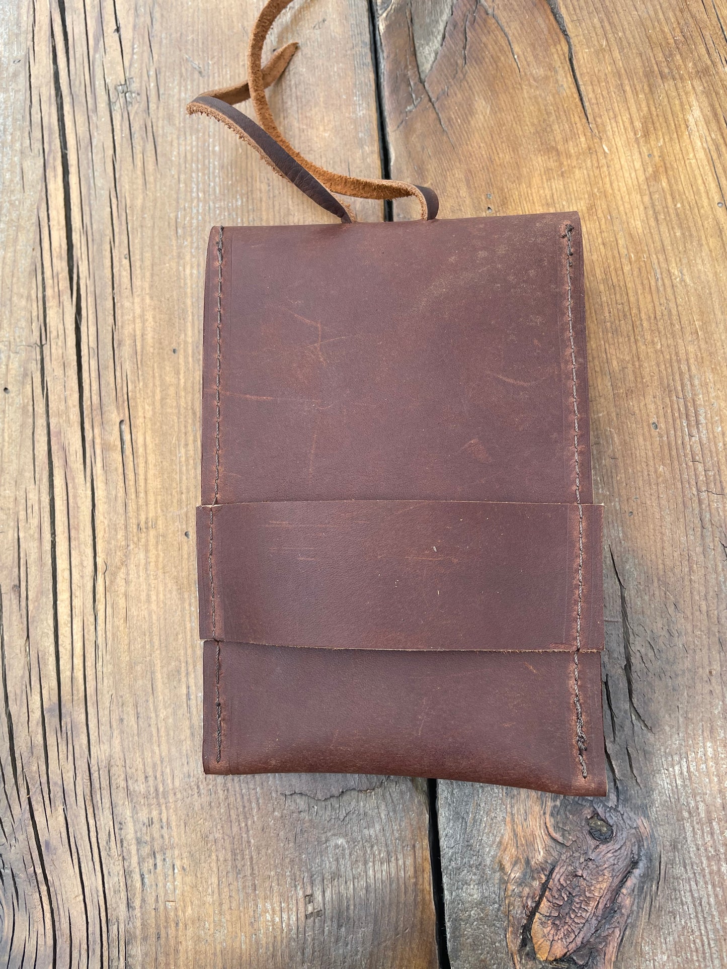 Saddle pouch cell phone holder