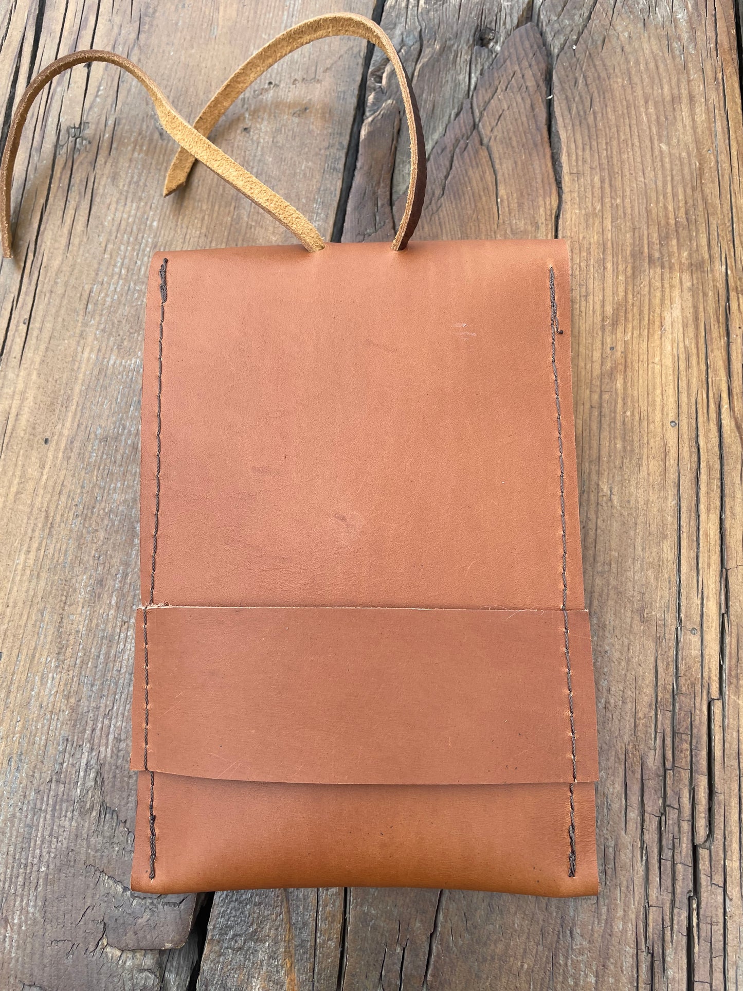 Saddle pouch cell phone holder