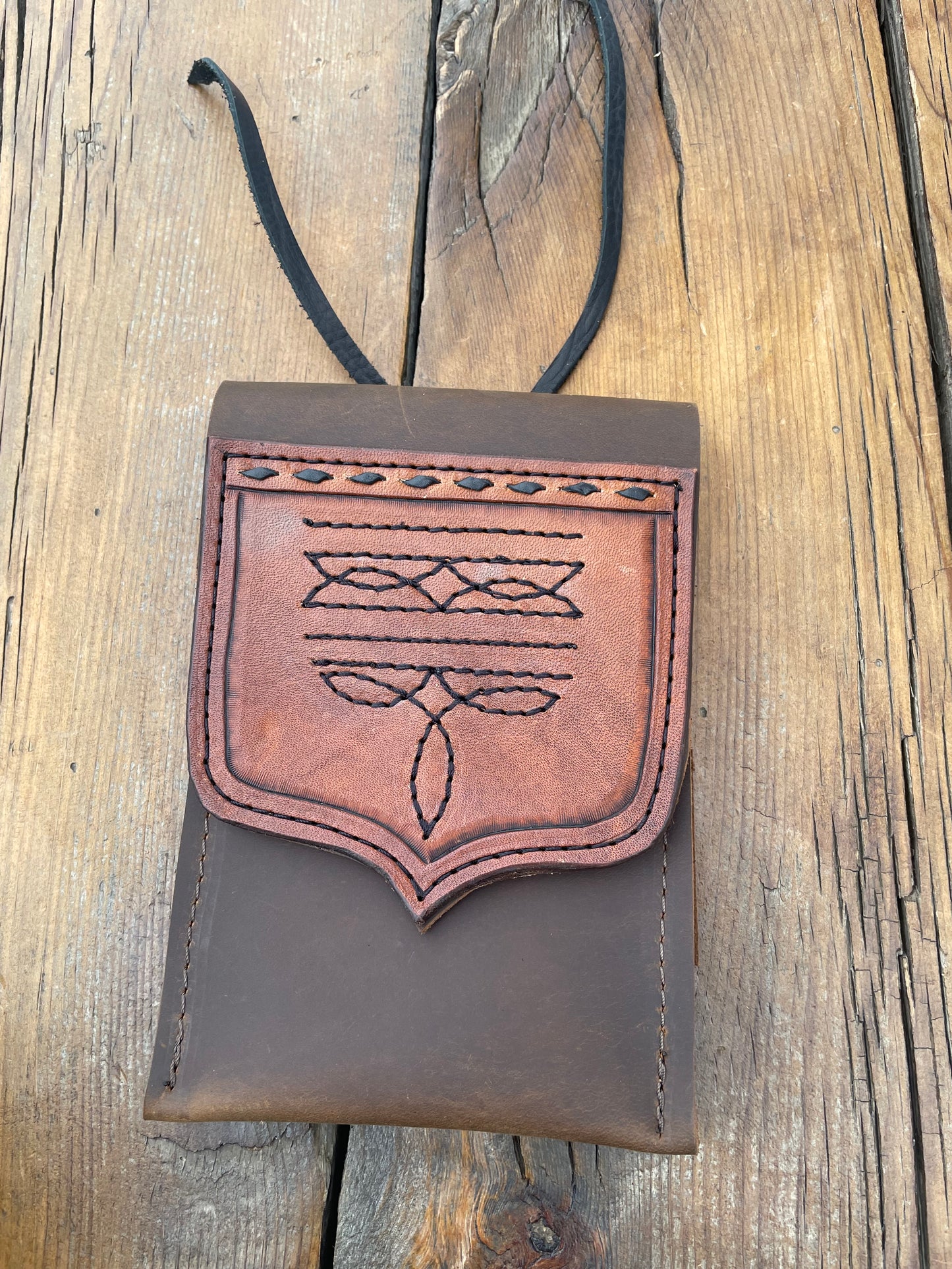 Saddle pouch cell phone holder