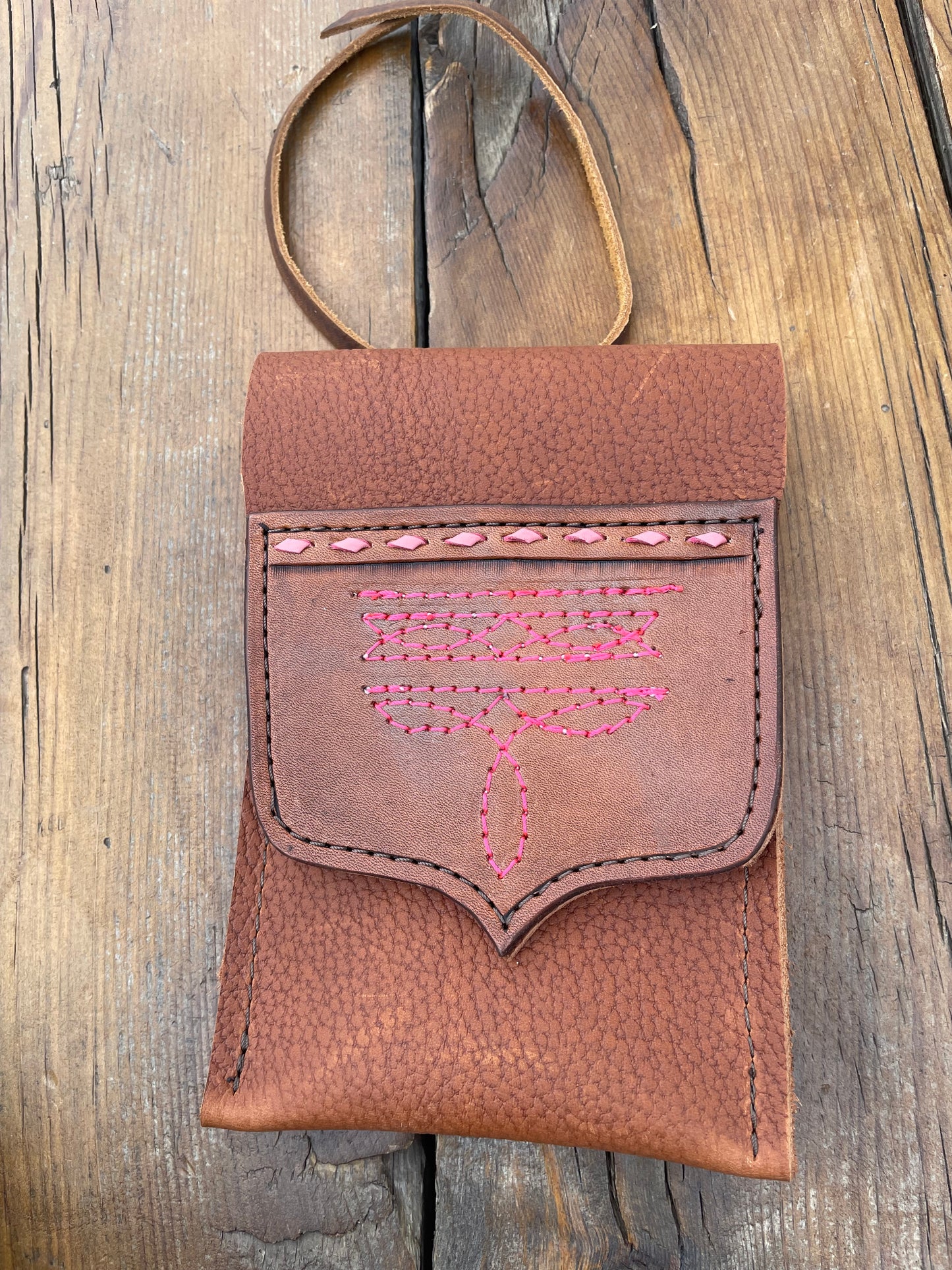 Saddle pouch cell phone holder