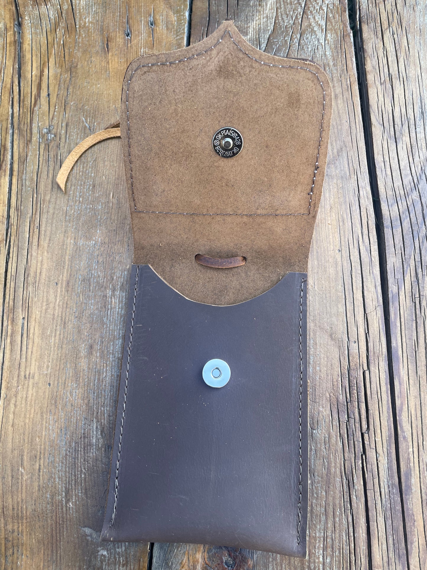 Saddle pouch cell phone holder