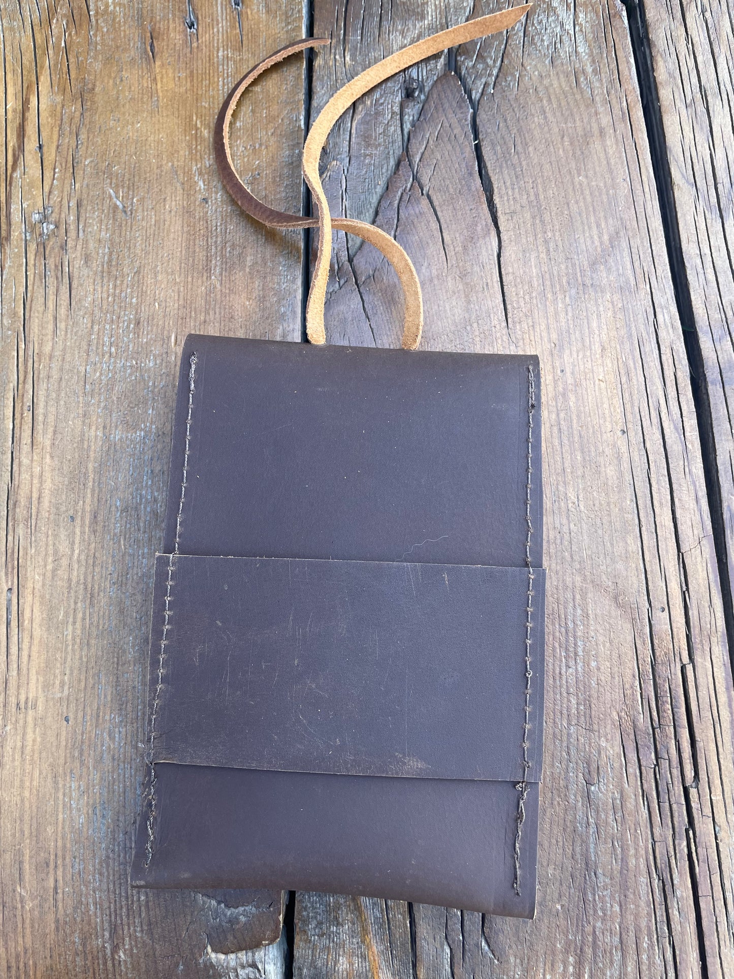 Saddle pouch cell phone holder