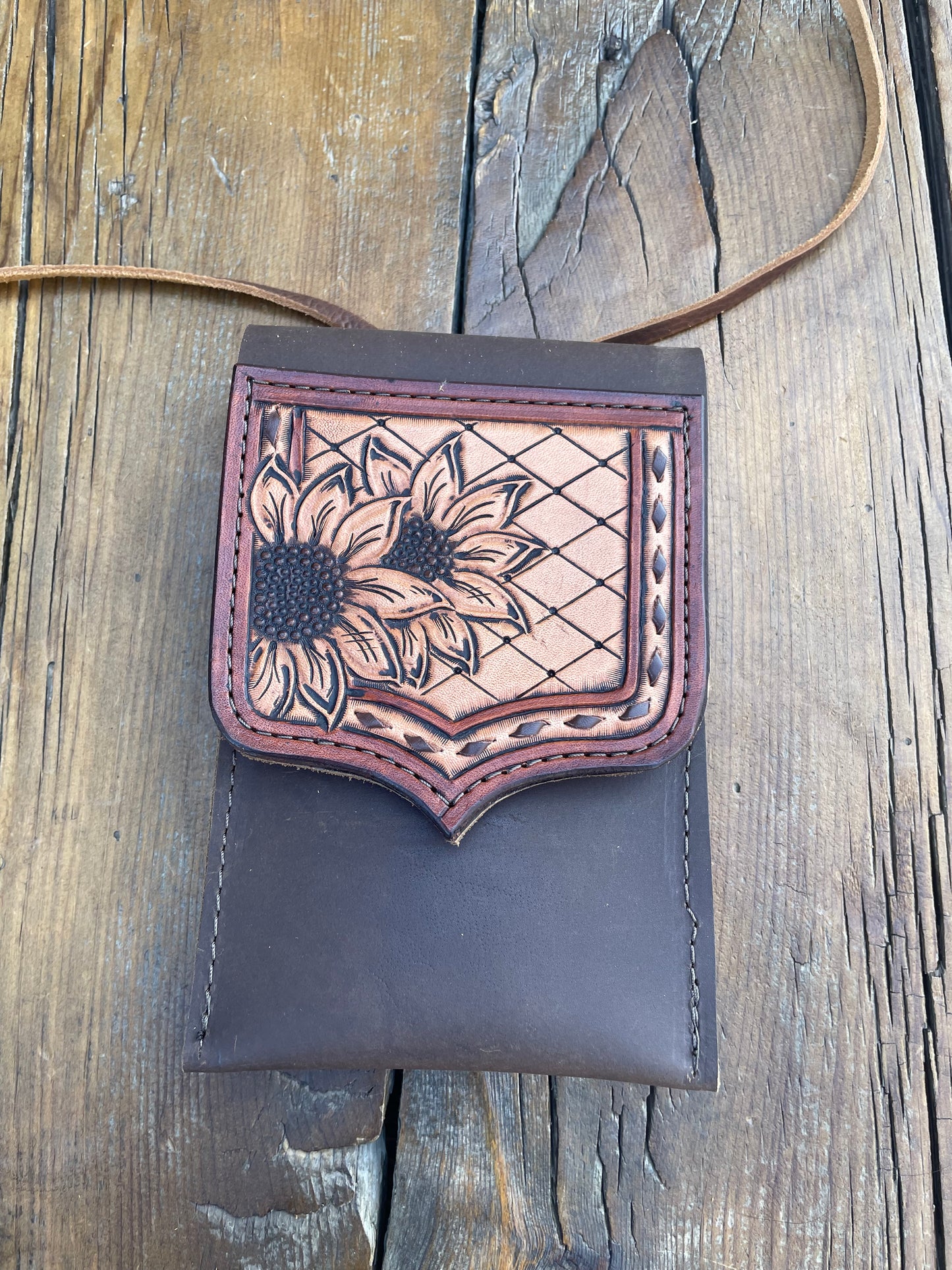 Saddle pouch cell phone holder