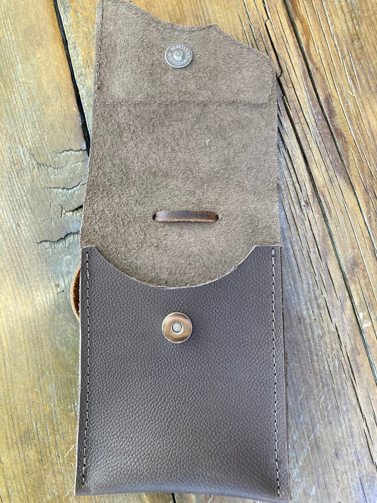 Saddle pouch cell phone holder