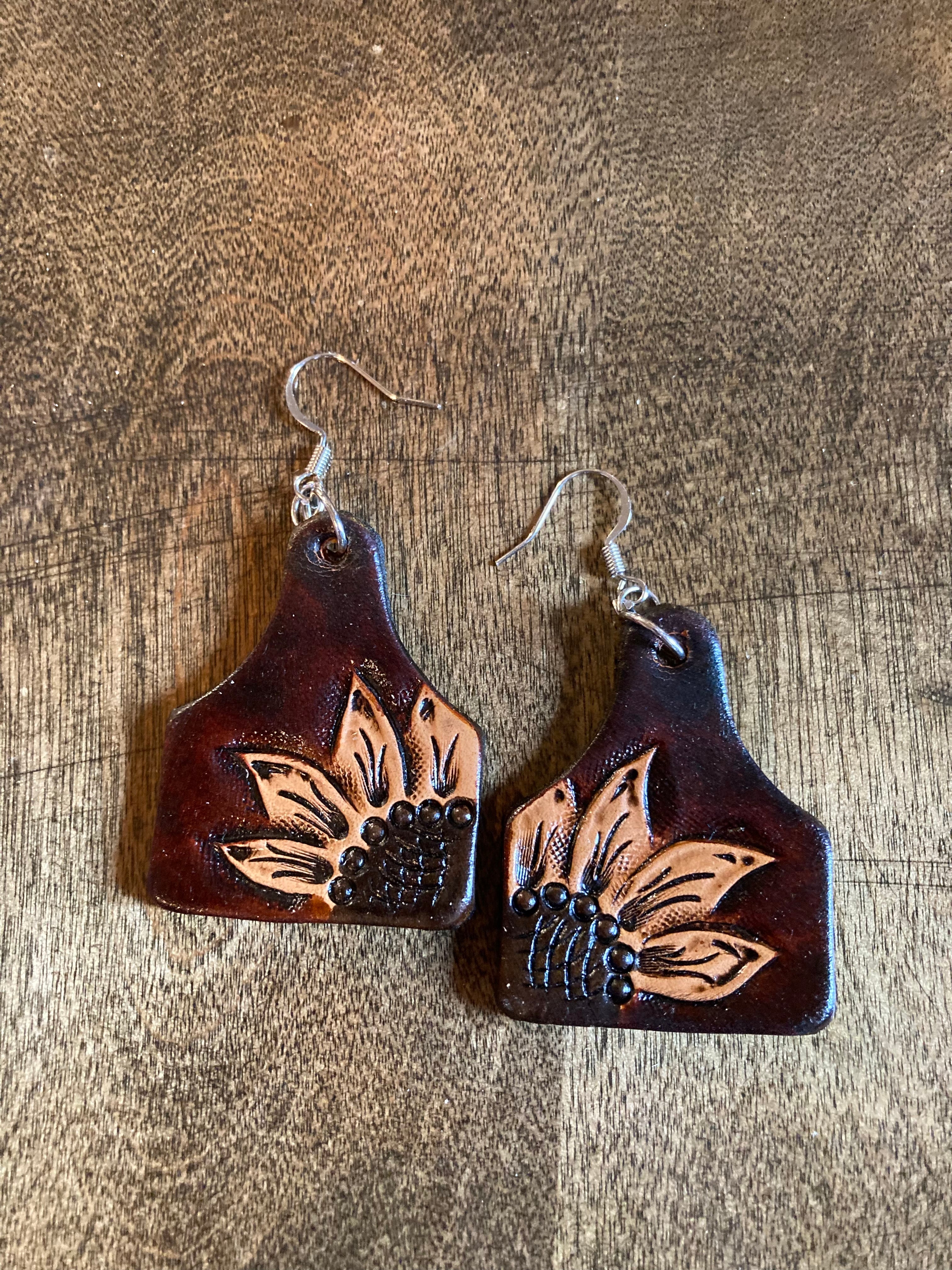 Leather cow store tag earrings