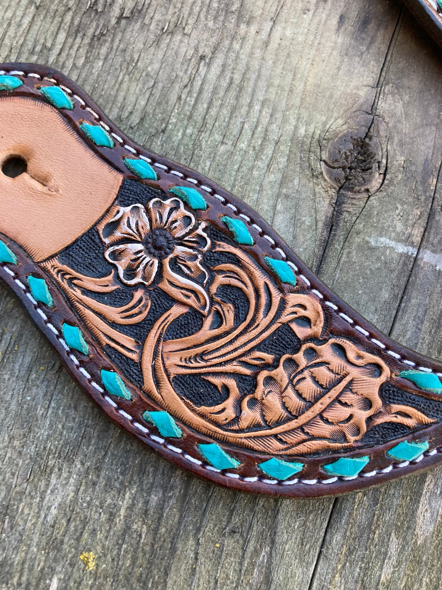 Spur straps with turquoise buck stitch and floral tooling